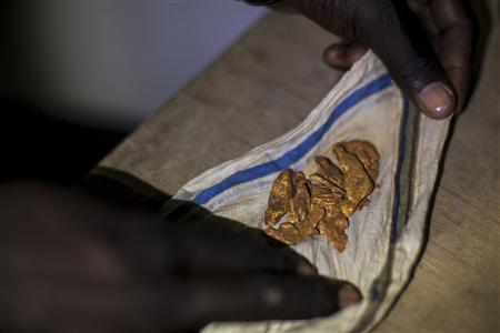 A man shows off his gold to potential buyers in a hotel in Kapoeta, South Sudan
