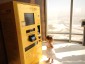 A little girl using gold vending machine to buy gold